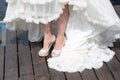 Legs shoes girls white dress wooden pier Royalty Free Stock Photo