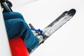 Legs of a skier with skis on the background of snow-covered fields. View from the cabin of the open lift. The concept of