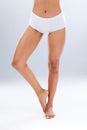 Legs, skin and epilation with beauty and woman in underwear, skincare and glow on studio background. Feet, pedicure and