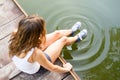 Legs in sneakers making circles in a water Royalty Free Stock Photo