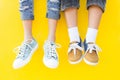 Legs sneakers on yellow background, lifestyle fashion