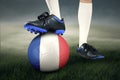 Legs of soccer player and ball