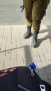 legs of a soldier in green trousers and military boots, a man with a machine gun, weapons, Israeli army Royalty Free Stock Photo