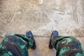 Legs of soldiers wearing leather boots, combats on cement floors, background images Royalty Free Stock Photo