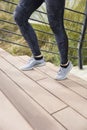 Legs of the female runner athlete going up stairs in urban city doing cardio sport workout run during summer Royalty Free Stock Photo
