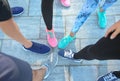 Legs of sporty young people standing in circle outdoors Royalty Free Stock Photo
