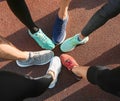 Legs of sporty young people standing in circle outdoors Royalty Free Stock Photo