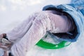 legs with sticky snow. clothing for walking in winter and sledding.