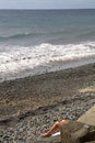 Legs of sunbather on beach