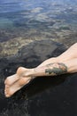 Legs of tattooed woman. Royalty Free Stock Photo