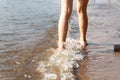 legs teenager on the sandy beach close-up. summer holiday