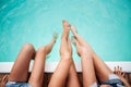 Legs of three young women in swimming pool Royalty Free Stock Photo