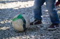 Legs of toddler boy kicks a soccer ball outdoors at sunny day Royalty Free Stock Photo