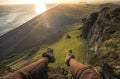 Legs of tourist in tracking shoes and view of Black sand beach in Iceland Royalty Free Stock Photo