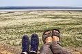 Legs of traveler family sitting on a high mountain freedom conce Royalty Free Stock Photo