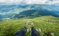 Legs of the traveler in hiking boots in the mountains Royalty Free Stock Photo