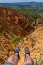 Legs of traveler with mountain boots in Badlands of Ponton de la Oliva, Madrid, Spain