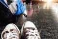 Legs of traveler sitting at the train station top in travel Royalty Free Stock Photo