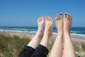 Legs of two women sunbathing on the beach Royalty Free Stock Photo