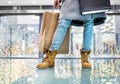 Legs of senior woman with bag doing Christmas shopping. Royalty Free Stock Photo