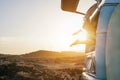 Legs view of happy surfer girl inside minivan at sunset - Young woman having fun on summer vacation - Travel,sport and nature Royalty Free Stock Photo