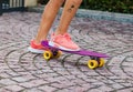 Teenager girl riding skateboard, legs