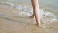 Legs walking on the beach on vacation, summer theme