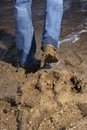 Legs walking through mud. Royalty Free Stock Photo