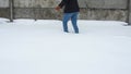 Legs walking on snow with footprints. Woman paves the way through a snowy field.