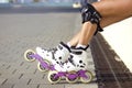 Legs wearing cute white and pink inline roller blades and protection Royalty Free Stock Photo