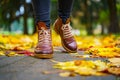 Legs of a woman in brown boots walking in a park Royalty Free Stock Photo