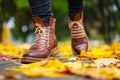 Legs of a woman in brown boots walking in a park Royalty Free Stock Photo