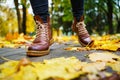 Legs of a woman in brown boots walking in a park Royalty Free Stock Photo