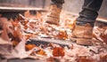 Legs of a woman in brown boots in autumn park Royalty Free Stock Photo