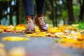 Legs of a woman in brown boots walking in a park Royalty Free Stock Photo