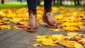 Legs of a woman in brown boots walking in a park Royalty Free Stock Photo