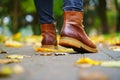 Legs of a woman in brown boots walking in a park Royalty Free Stock Photo