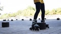 Legs of woman dodging bollards with skates