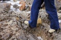 Legs of a woman hiker walks over rocks