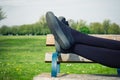 The legs of a woman lying on a bench Royalty Free Stock Photo