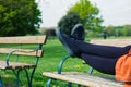 The legs of a woman lying on a bench Royalty Free Stock Photo