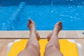 Legs of a woman relaxing poolside Royalty Free Stock Photo