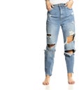 Legs of a woman in ripped jeans Royalty Free Stock Photo