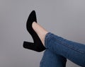 Legs of woman in stylish high shoes, on gray background Royalty Free Stock Photo