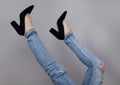 Legs of woman in stylish high shoes, on gray background Royalty Free Stock Photo