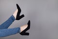 Legs of woman in stylish high shoes, on gray background Royalty Free Stock Photo