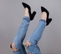 Legs of woman in stylish high shoes, on gray background Royalty Free Stock Photo