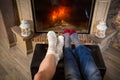 Legs in woolen socks heat up near fireplace, above view Royalty Free Stock Photo