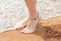 Legs of a young girl and anklet ankle Royalty Free Stock Photo