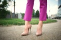 legs of a young girl in heels stand on the street